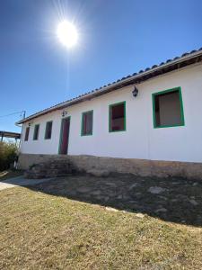 a white building with the sun in the sky at Pousada Casa Matriz in Itabirito +12 photos