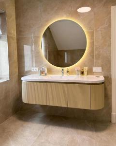 a bathroom with a sink and a mirror at Residence Riverside in Mostar +82 photos