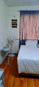 a bedroom with a bed and a table and a table at Linaste at Colosseum in Johannesburg