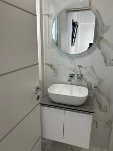 a bathroom with a white sink and a mirror at Villa Medusa in Skala Prinou +17 photos
