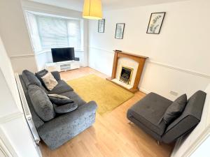 a living room with a couch and a fireplace at House number 12 sleeps up to 4 with Smart TVs in every room in Wellington