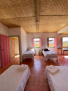 a large room with two beds in a room at Pousada Casa Matriz in Itabirito