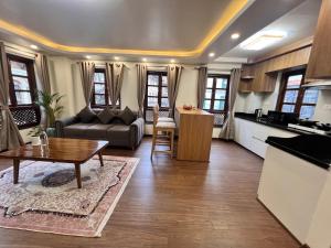 a living room with a couch and a table at Heritage Service Apartment in Pātan +26 photos