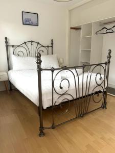 a bedroom with a black metal bed with white sheets at House number 12 sleeps up to 4 with Smart TVs in every room in Wellington