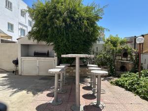 a group of stools sitting in front of a tree at White House Nicosia in Nicosia