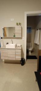 a bathroom with a sink and a toilet at Casa Rosário Centro de Amparo in Amparo +25 photos