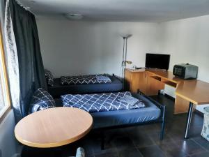 a small room with a bed and a table at Ferienpark am Hellsee in Biesenthal