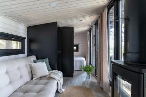 a living room with a couch and a fireplace at Palas Experience Olkkajärvi Resort in Rovaniemi +15 photos