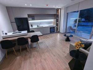 a kitchen and living room with a table and chairs at Top quality, great location! in Cuenca