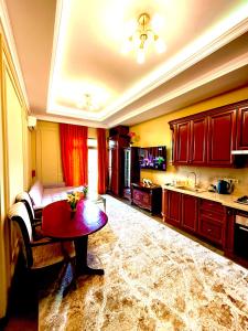 a large kitchen with a red table and a kitchen with at Boulevard Tashkent City 02 in Tashkent