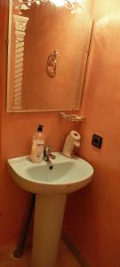 a bathroom with a white sink and a mirror at Atlas Pearl lodge in Imlil +89 photos
