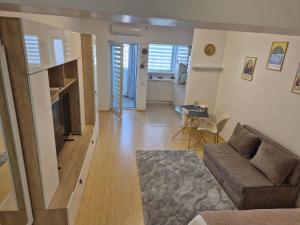 a living room with a couch and a table at ZenCozy Studio - Free Underground Parking in Bucharest