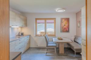 a kitchen with a table and a dining room at Apartment "Haus Edelweiss" in Scharnitz