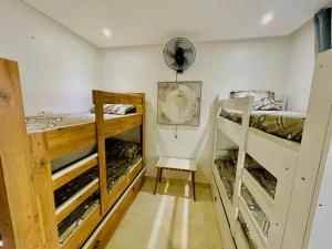 a room with two bunk beds and a fan at sonu at Hostel in Dakar