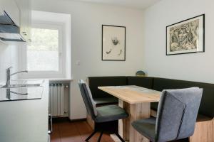 a dining room with a wooden table and chairs at Ciasa Silvano 1721 SV in Falcade