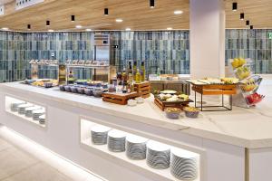 ein Buffet mit ausgestellten Tellern und Speisen in der Unterkunft Sport Hotel Monte Feliz - powered by Playitas in Playa del Aguila