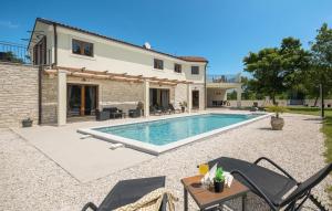 a villa with a swimming pool in front of a house at Villa Sole Mio by Villas Guide in Crnibek