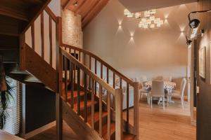 a staircase leading to a dining room with a table at Przystań Spokoju in Chmielno