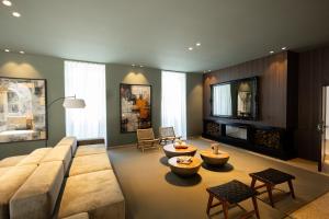 a living room with a large couch and a fire place at The Lince Braga in Braga