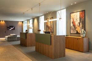 a lobby with a reception desk in a building at The Lince Braga in Braga