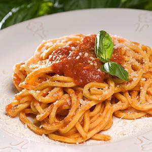 a plate of spaghetti with sauce and a basil leaf at La Collinetta sas in Montazzoli
