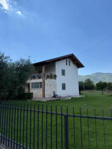 a white house with a fence in front of it at B&B La Coccinella in Amaseno