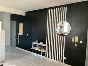 a black and white room with a mirror and a table at L'atelier Monochrome in Montjoly
