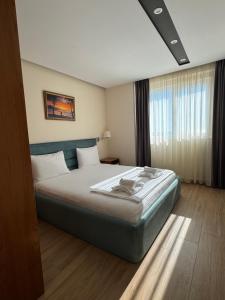 a bedroom with a large bed in a room at Milenium Hotel in Shëngjin