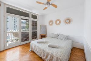 a bedroom with a bed and a ceiling fan at Apartman Zvezda in Igalo