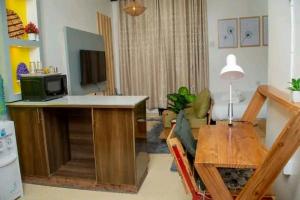 a living room with a table and a microwave at Liza N Homes in Bungoma