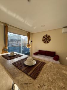 a living room with a table and a couch at Casinhas da Vila in Itacaré