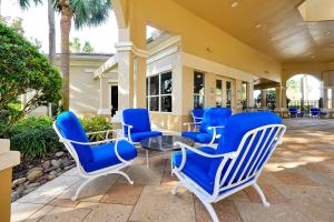 a group of blue chairs and a table on a patio at Mickey's Hideaway Windsor Hills Resort in Orlando
