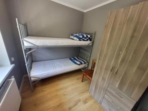 a room with two bunk beds and a door at Pokoje Gościnne Grzybowo in Grzybowo