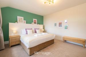 a bedroom with a large bed and green walls at Woodside, Get away with Hot Tub, near Fraserburgh in Strichen