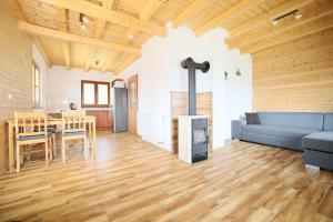 a living room with a blue couch and a wood stove at Kovarov26 in Frymburk +17 photos