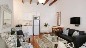 a living room with a couch and a table at Cottage 1 at River Bend in Graaff-Reinet