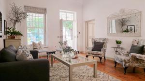 a living room with a couch and chairs and a table at Cottage 1 at River Bend in Graaff-Reinet