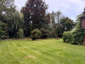 a grassy yard with a picnic table and trees at Da Vinci Guest House Gatwick Guest Parking, A Real Gem in Crawley