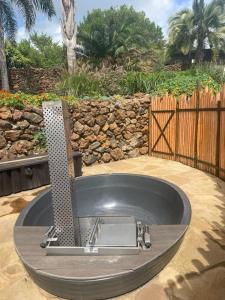 a bath tub in a yard with a fence at O'Leleshwa Retreat in Naivasha