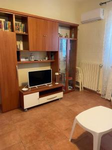 a living room with a tv and a table at Casa Celestina sul mare in Monopoli