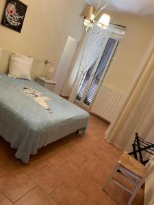 a bedroom with a bed and a window and a chair at Casa Celestina sul mare in Monopoli