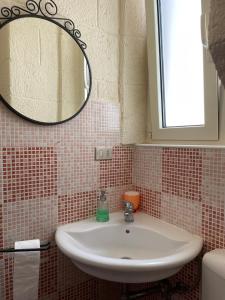 a bathroom with a sink and a mirror at Casa Celestina sul mare in Monopoli