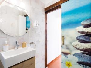 a bathroom with a sink and a stack of rocks at EK Apartamento en Candelaria A in Candelaria