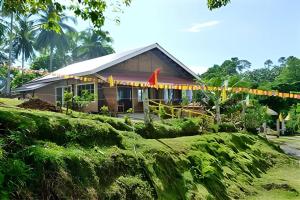 a house with flags in front of it at D & A Seaside Cottages in Catarman
