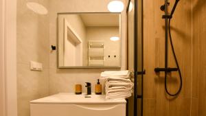 a bathroom with a sink and a mirror at VacationClub - Słoneczne Osiedle Apartament 17 in Ustronie Morskie +8 photos