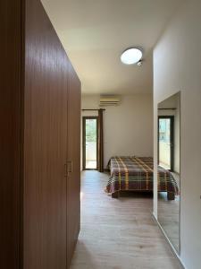 a bedroom with a bed and a door to a room at Laforge Residence in Al Bāţiyah