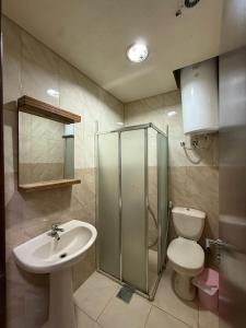 a bathroom with a toilet and a sink and a shower at Laforge Residence in Al Bāţiyah +28 photos