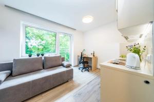 a living room with a couch and a window at HomeKoko Apartments in Katowice