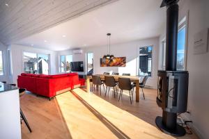 a living room with a red couch and a fireplace at Mountain View - World Cup in Beaupré +41 photos