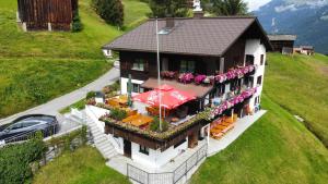 an aerial view of a house with a table and chairs at Alpinchalet Zigjam in Gaschurn